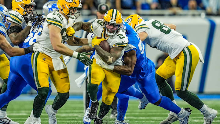 Green Bay Packers running back Josh Jacobs breaks through the Detroit Lions defensive line before being tackled during the Thursday Night Football game at Ford Field in Detroit on Thursday, Dec. 5, 2024. Jacobs scored three rushing touchdowns in the Lions' 34-31 win.