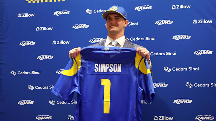 Los Angeles Rams first-round draft pick Ty Simpson poses with his jersey during a press conference.