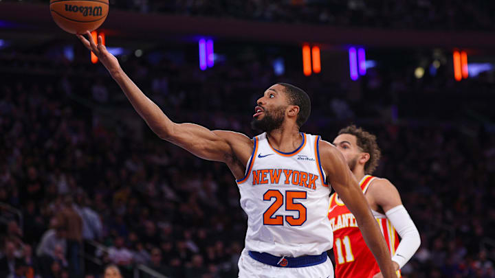 Jan 20, 2025; New York, New York, USA; New York Knicks forward Mikal Bridges (25) goes to the basket in front of Atlanta Hawks guard Trae Young (11) during the first half at Madison Square Garden. Mandatory Credit: Vincent Carchietta-Imagn Images