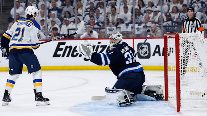 Apr 19, 2025; Winnipeg, Manitoba, CAN; St. Louis Blues forward Robert Thomas (18) (not shown) scores on Winnipeg Jets goalie Connor Hellebuyck (37) during the first period in game one of the first round of the 2025 Stanley Cup Playoffs at Canada Life Centre. Mandatory Credit: Terrence Lee-Imagn Images
