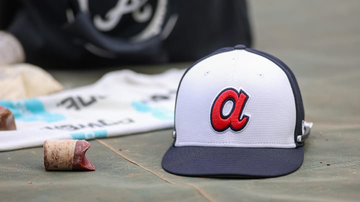 A detailed view of an Atlanta Braves hat on the field during batting practice at Truist Park. The game against the New York Mets was postponed due to impending weather. 