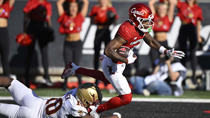 Sep 23, 2023; Louisville, Kentucky, USA;  Louisville Cardinals wide receiver Ahmari Huggins-Bruce (9) scores a touchdown despite the efforts of Boston College Eagles defensive back Jalen Cheek (10) during the second half at L&N Federal Credit Union Stadium. Louisville defeated Boston College 56-28. 