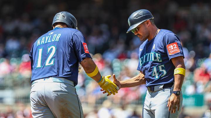 Sep 7, 2025; Cumberland, Georgia, USA; Seattle Mariners first base Josh Naylor (12) high fives third bas coach Kristopher Negron (45) after hitting a home run against the Atlanta Braves during the second inning at Truist Park. Mandatory Credit: Jordan Godfree-Imagn Images Sep 7, 2025; Cumberland, Georgia, USA; Seattle Mariners first base Josh Naylor (12) high fives third bas coach Kristopher Negron (45) after hitting a home run against the Atlanta Braves during the second inning at Truist Park. Mandatory Credit: Jordan Godfree-Imagn Images