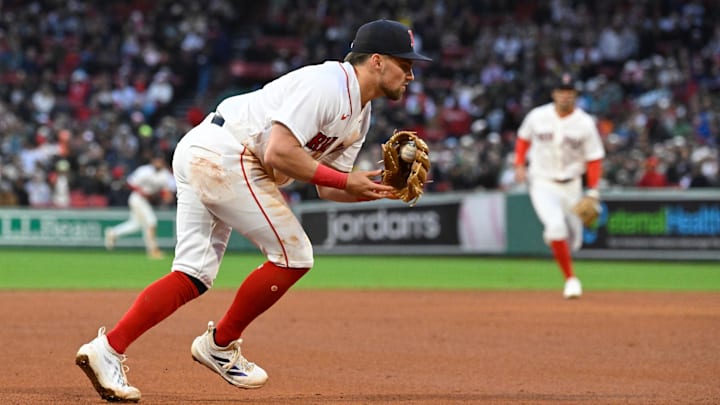 Apr 4, 2026; Foxborough, Massachusetts, USA; Boston Red Sox third baseman Caleb Durbin (5) makes a catch and throw to first base for an out against the San Diego Padres during the seventh inning at Fenway Park. Mandatory Credit: Eric Canha-Imagn Images