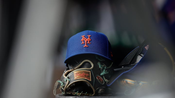 Aug 8, 2024; Denver, Colorado, USA; A New York Mets hat and glove in the dugout in the second inning against the Colorado Rockies at Coors Field. Mandatory Credit: Isaiah J. Downing-Imagn Images