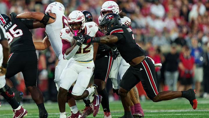 Oct 9, 2026; Louisville, Kentucky, USA;  Louisville Cardinals defensive line Tyler Thompson (3) tackles Florida State Seminoles running back Ousmane Kromah (32) during the first quarter of the game against the Florida State Seminoles at L&N Federal Credit Union Stadium.  Mandatory Credit: Chris Carter-Imagn Images