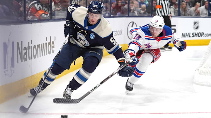 Blue Jackets forward Yegor Chinakhov plays the puck ahead of Rangers forward Vincent Trocheck. Blue Jackets forward Yegor Chinakhov plays the puck ahead of Rangers forward Vincent Trocheck.