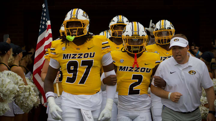 Sep 21, 2024; Columbia, Missouri, USA; Head coach Eli Drinkwitz (right), along with defensive back Toriano Pride Jr. (2) and defensive end Eddie Kelly Jr, (97) leads the Missouri Tigers out of the tunnel against Commodores at Faurot Field at Memorial Stadium. Sep 21, 2024; Columbia, Missouri, USA; Head coach Eli Drinkwitz (right), along with defensive back Toriano Pride Jr. (2) and defensive end Eddie Kelly Jr, (97) leads the Missouri Tigers out of the tunnel against Commodores at Faurot Field at Memorial Stadium.