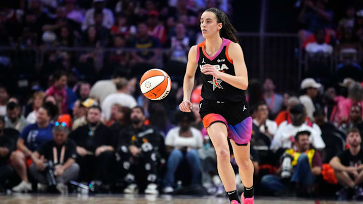 Team WNBA guard Clark dribbles up the court against Team USA during the WNBA All-Star Game.