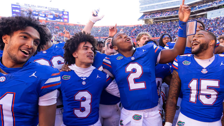 Florida Gators quarterback DJ Lagway (2) celebrates at Ben Hill Griffin Stadium with teammates Florida Gators running back Florida Gators wide receiver Aidan Mizell (11), Florida Gators wide receiver Eugene Wilson III (3) and Florida Gators linebacker Derek Wingo (15) in Gainesville, FL on Saturday, November 23, 2024. The Gators defeated the Rebels 24-17 [Doug Engle/Gainesville Sun]