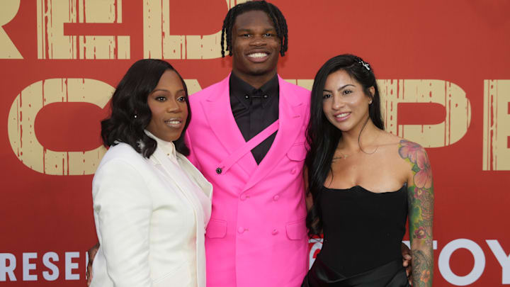 Apr 24, 2025; Green Bay, WI, USA; Colorado Buffaloes wide receiver Travis Hunter with his mother Ferrante Harris and his fiancee at the time Leanna Lenee on the red carpet before the 2025 NFL Draft at Lambeau Field. 