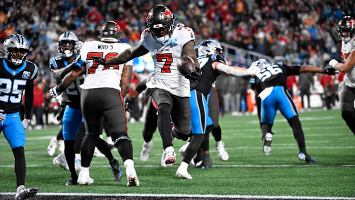 Dec 1, 2024; Charlotte, North Carolina, USA; Tampa Bay Buccaneers running back Bucky Irving (7) scores a touchdown in the fourth quarter at Bank of America Stadium. Mandatory Credit: Bob Donnan-Imagn Images