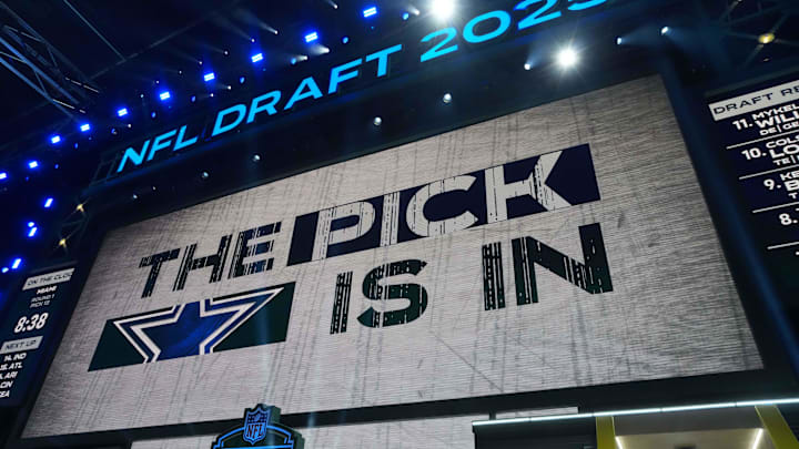 The Dallas Cowboys logo is projected on the video board during the NFL Draft at Lambeau Field. The Dallas Cowboys logo is projected on the video board during the NFL Draft at Lambeau Field.
