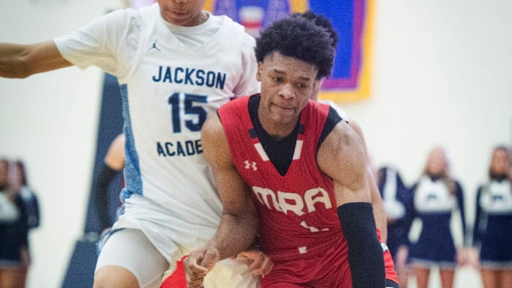 Madison-Ridgeland 's Ashton Magee (1) pushes past JA's Mason Williams (15) during the MAIS Overall Basketball Tournament in Clinton, Miss., Wednesday, Feb. 28, 2024.