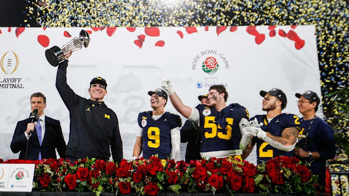 Michigan head coach Jim Harbaugh lifts up the Rose Bowl trophy after a 27-20 win over Alabama in the College Football Playoff semifinal at the Rose Bowl in Pasadena, California.