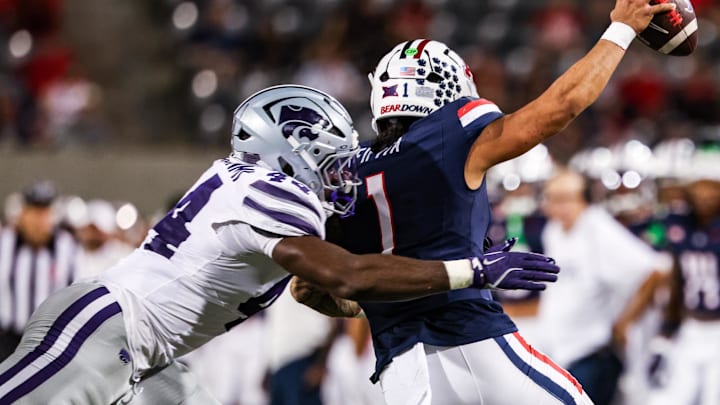 Sep 12, 2025; Tucson, Arizona, USA; Kansas State Wildcats defensive end Tobi Osunsanmi (44) tackles Arizona Wildcats quarterback Noah Fifita (1) during the third quarter of the game at Arizona Stadium.