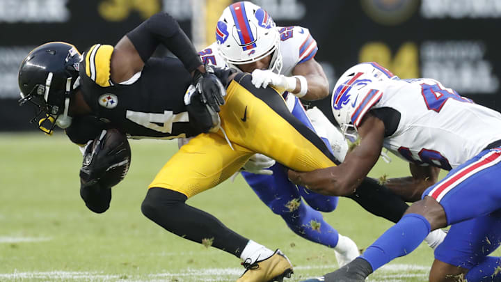 Aug 17, 2024; Pittsburgh, Pennsylvania, USA;  Pittsburgh Steelers wide receiver George Pickens (14)/ runs after a  catch as Buffalo Bills cornerback Daequan Hardy (25) and cornerback Ja'Marcus Ingram (46) tackle during the second quarter  at Acrisure Stadium. Mandatory Credit: Charles LeClaire-USA TODAY Sports