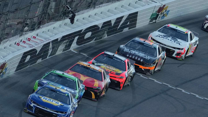 Chase Elliott (9) leads a line of cars through the tri-oval in the Daytona 500 on Monday, February 19, 2024.