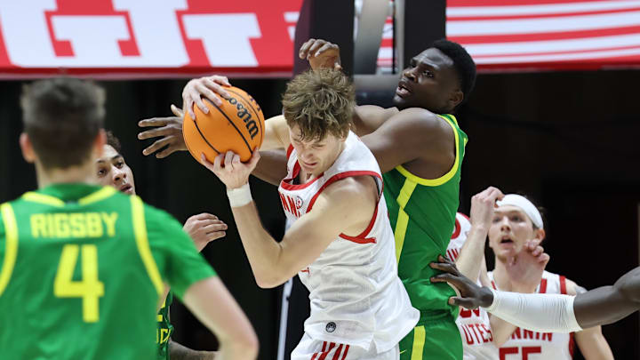 Jan 21, 2024; Salt Lake City, Utah, USA; Utah Utes guard Cole Bajema (2) and Oregon Ducks center N'Faly Dante (1) go after the ball.