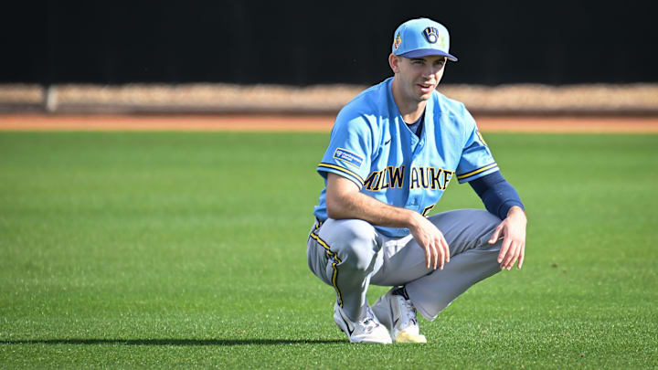 Milwaukee Brewers pitcher Robert Gasser (54) stretches in the outfield during spring training workouts Sunday, February 15, 2026, at American Family Fields of Phoenix in Phoenix, Arizona.