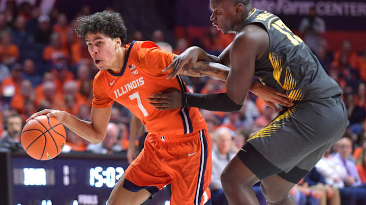 Feb 25, 2025; Champaign, Illinois, USA;  Illinois Fighting Illini forward Will Riley (7) drives the ball past Iowa Hawkeyes forward Ladji Dembele (13) during the
first half at State Farm Center. Mandatory Credit: Ron Johnson-Imagn Images
