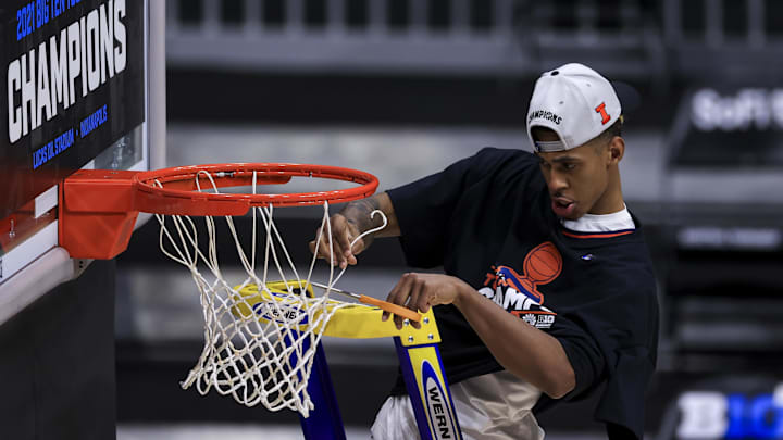 Mar 14, 2021; Indianapolis, Indiana, USA; Illinois Fighting Illini guard Adam Miller (44) cuts down a piece of the net after defeating the Ohio State Buckeyes at Lucas Oil Stadium. Mandatory Credit: Aaron Doster-Imagn Images