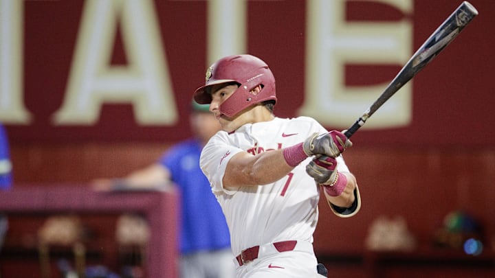 Florida State catcher Jaime Ferrer (7) watches as the ball he hits flies out of the ballpark for a