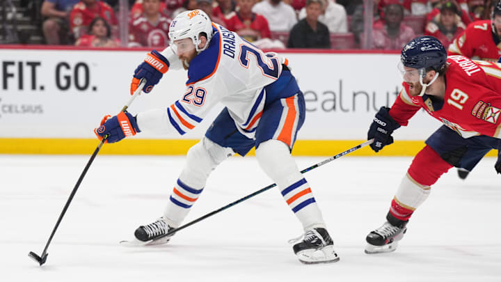 Edmonton Oilers center Leon Draisaitl battles for the puck against Florida Panthers forward Matthew Tkachuk.