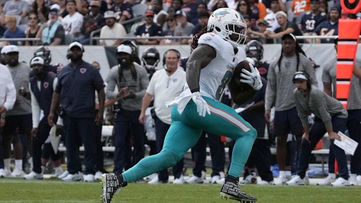 Miami Dolphins running back Alexander Mattison (8) runs the ball against the Chicago Bears during the second half at Soldier Field on Sunday.