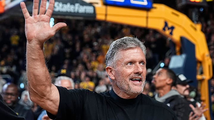 Michigan football head coach Kyle Whittingham waves at the crowd as he is being introduced on the floor during the first half between Michigan and USC at Crisler Center in Ann Arbor on Friday, Jan. 2, 2026.