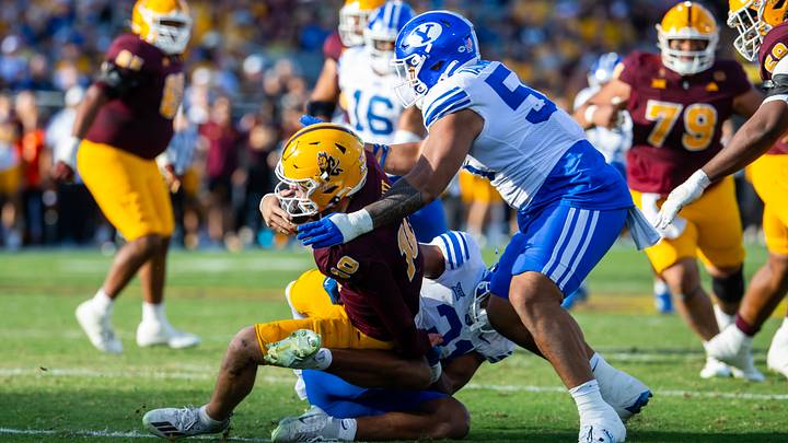 Nov 23, 2024; Tempe, Arizona, USA; Brigham Young Cougars defensive tackle John Taumoepeau (55) sacks Arizona State Sun Devils quarterback Sam Leavitt (10) at Mountain America Stadium. Mandatory Credit: Mark J. Rebilas-Imagn Images Nov 23, 2024; Tempe, Arizona, USA; Brigham Young Cougars defensive tackle John Taumoepeau (55) sacks Arizona State Sun Devils quarterback Sam Leavitt (10) at Mountain America Stadium. Mandatory Credit: Mark J. Rebilas-Imagn Images