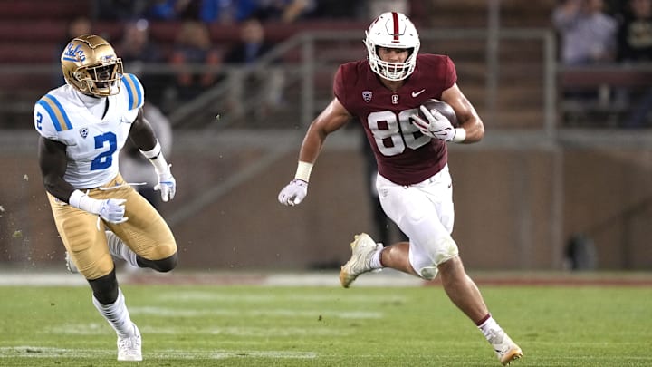 Oct 21, 2023; Stanford, California, USA; Stanford Cardinal tight end Sam Roush (86) runs after a catch against UCLA Bruins linebacker Oluwafemi Oladejo (2) during the third quarter at Stanford Stadium. Mandatory Credit: Darren Yamashita-Imagn Images