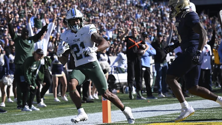 Nov 16, 2024; Annapolis, Maryland, USA; Tulane Green Wave running back Makhi Hughes (21) scores in front of Navy Midshipmen safety Kenneth McShan (0) during the second half  at Navy-Marine Corps Memorial Stadium. Mandatory Credit: Tommy Gilligan-Imagn Images