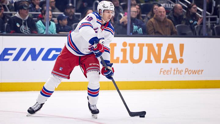 Nov 1, 2025; Seattle, Washington, USA; New York Rangers defenseman Urho Vaakanainen (18) passes the puck during the first period against the Seattle Kraken at Climate Pledge Arena. Mandatory Credit: Blake Dahlin-Imagn Images