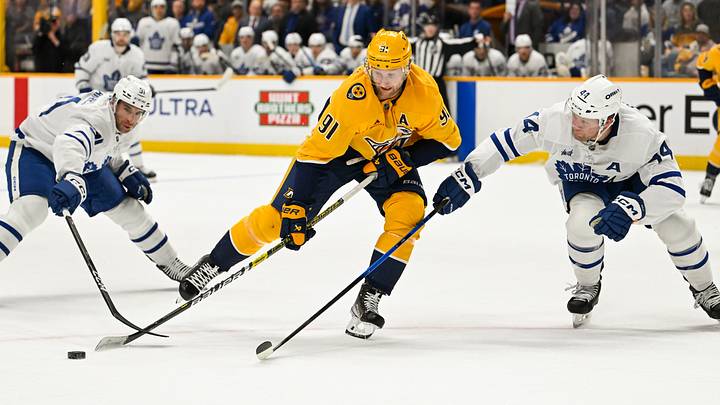 Dec 20, 2025; Nashville, Tennessee, USA; Toronto Maple Leafs center John Tavares (91), defenseman Morgan Rielly (44) and Nashville Predators center Steven Stamkos (91) battle for the puck during the first period at Bridgestone Arena. Mandatory Credit: Steve Roberts-Imagn Images Dec 20, 2025; Nashville, Tennessee, USA; Toronto Maple Leafs center John Tavares (91), defenseman Morgan Rielly (44) and Nashville Predators center Steven Stamkos (91) battle for the puck during the first period at Bridgestone Arena. Mandatory Credit: Steve Roberts-Imagn Images
