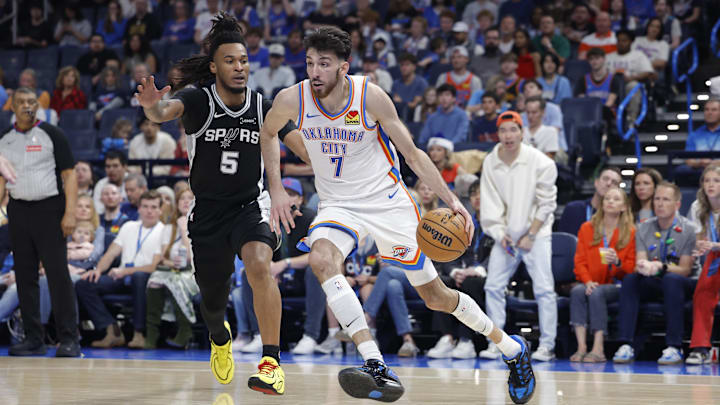 Dec 25, 2025; Oklahoma City, Oklahoma, USA; Oklahoma City Thunder center Chet Holmgren (7) drives to the basket beside San Antonio Spurs guard Stephon Castle (5) during the second half at Paycom Center. Mandatory Credit: Alonzo Adams-Imagn Images