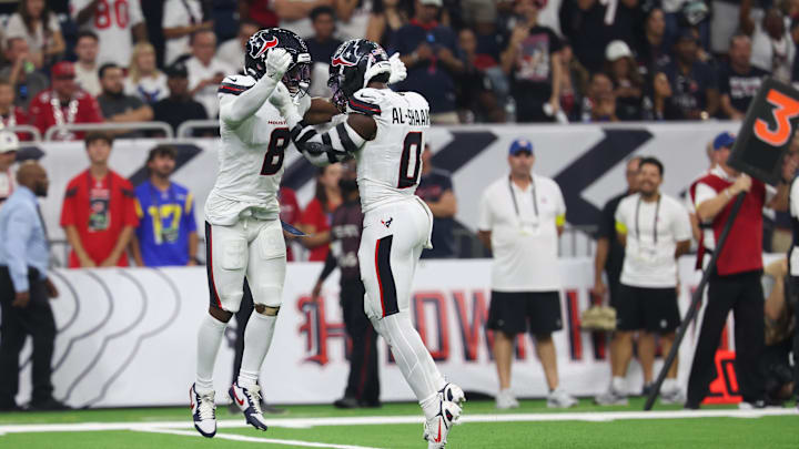 Sep 15, 2025; Houston, Texas, USA; Houston Texans safety C.J. Gardner-Johnson (8) and Houston Texans linebacker Azeez Al-Shaair (0) celebrate after making a tackle during the second quarter against the Tampa Bay Buccaneers at NRG Stadium. Mandatory Credit: Thomas Shea-Imagn Images