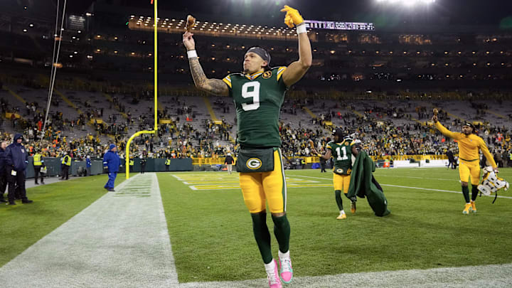 Nov 28, 2024; Green Bay, Wisconsin, USA;  Green Bay Packers wide receiver Christian Watson (9) celebrates while holding a turkey leg on his way off the field following the game against the Miami Dolphins at Lambeau Field. Mandatory Credit: Jeff Hanisch-Imagn Images