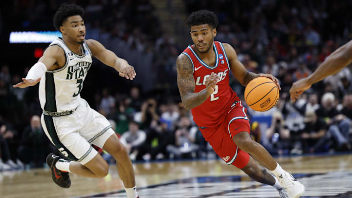 New Mexico Lobos guard Donovan Dent (2) dribbles in the second half against the Michigan State Spartans during the NCAA Tournament Second Round at Rocket Arena New Mexico Lobos guard Donovan Dent (2) dribbles in the second half against the Michigan State Spartans during the NCAA Tournament Second Round at Rocket Arena