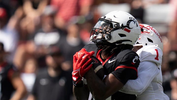 Cincinnati Bearcats receiver Barry Jackson Jr. (44) catches a pass as Houston Cougars defensive back Latrell McCutchin Sr. (1) tackles him in the third quarter of the College Football game at Nippert Stadium in Cincinnati on Saturday, Sept. 21, 2024.