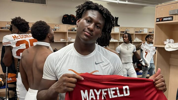 Texas Longhorns linebacker Anthony Hill, Jr. shows the torn and tattered Baker Mayfield jersey after beating Oklahoma.