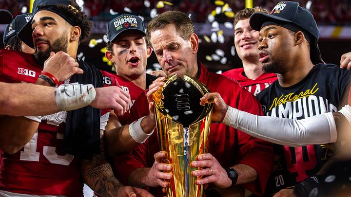 Indiana Head Coach Curt Cignetti prepares to lift the trophy on the podium after the College Football Playoff National Championship college football game at Hard Rock Stadium in Miami Gardens on Monday, Jan. 19, 2026. Indiana Head Coach Curt Cignetti prepares to lift the trophy on the podium after the College Football Playoff National Championship college football game at Hard Rock Stadium in Miami Gardens on Monday, Jan. 19, 2026.