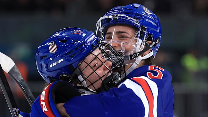 Feb 13, 2026; Milan, Italy; Britta Curl of United States celebrates with Megan Keller of United States after scoring their fifth goal against Italy in a women's ice hockey quarterfinal during the Milano Cortina 2026 Olympic Winter Games at Milano Rho Ice Hockey Arena. Mandatory Credit: Katie Stratman-Imagn Images