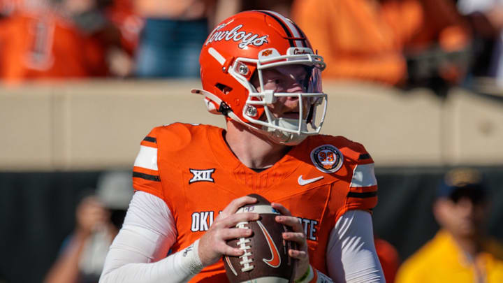 Oct 5, 2024; Stillwater, Oklahoma, USA; Oklahoma State Cowboys quarterback Alan Bowman (7) drops back to pass against the West Virginia Mountaineers during the first quarter at Boone Pickens Stadium. Mandatory Credit: William Purnell-Imagn Images