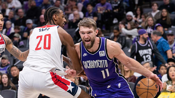 Jan 19, 2025; Sacramento, California, USA; Sacramento Kings forward Domantas Sabonis (11) drives to the basket against Washington Wizards forward Alexandre Sarr (20) during the third quarter at Golden 1 Center. Mandatory Credit: Ed Szczepanski-Imagn Images Jan 19, 2025; Sacramento, California, USA; Sacramento Kings forward Domantas Sabonis (11) drives to the basket against Washington Wizards forward Alexandre Sarr (20) during the third quarter at Golden 1 Center. Mandatory Credit: Ed Szczepanski-Imagn Images