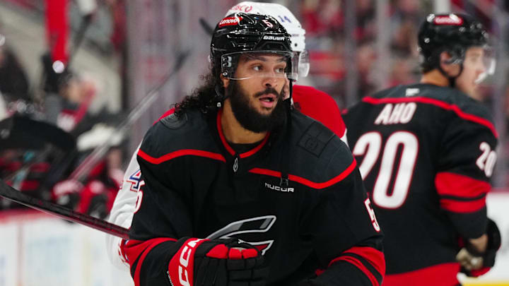 Mar 28, 2025; Raleigh, North Carolina, USA;  Carolina Hurricanes defenseman Jalen Chatfield (5) watches the play against the Montreal Canadiens during the second period at Lenovo Center. Mandatory Credit: James Guillory-Imagn Images