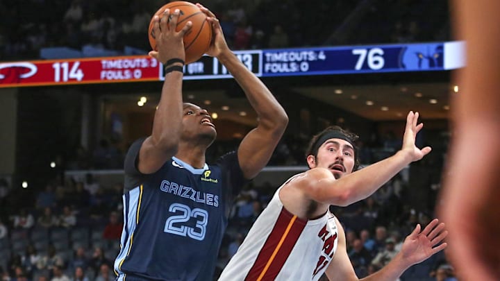Oct 24, 2025; Memphis, Tennessee, USA; Memphis Grizzlies forward Cedric Coward (23) drives to the basket as Miami Heat forward Jaime Jaquez Jr. (11) defends during the fourth quarter at FedExForum. Mandatory Credit: Petre Thomas-Imagn Images