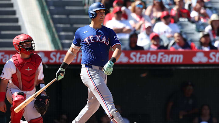 Sep 29, 2024; Anaheim, California, USA;  Texas Rangers first baseman Nathaniel Lowe (30) hits a home run during the eighth inning against the Los Angeles Angels at Angel Stadium. 
