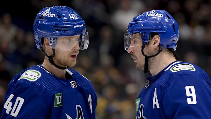 Feb 24, 2024; Vancouver, British Columbia, CAN;  Vancouver Canucks forward Elias Pettersson (40) and forward J.T. Miller (9) talk before a faceoff against the Boston Bruins  during the third period at Rogers Arena. Mandatory Credit: Anne-Marie Sorvin-Imagn Images