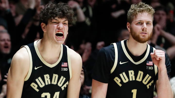 Purdue Boilermakers forwards Raleigh Burgess (34) and Caleb Furst (1) celebrate from the bench 